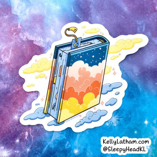 A die-cut sticker featuring a whimsical illustrated book with a starry blue cover and a sunset sky design on the pages, surrounded by clouds. The sticker is shown against a purple and blue galaxy background.