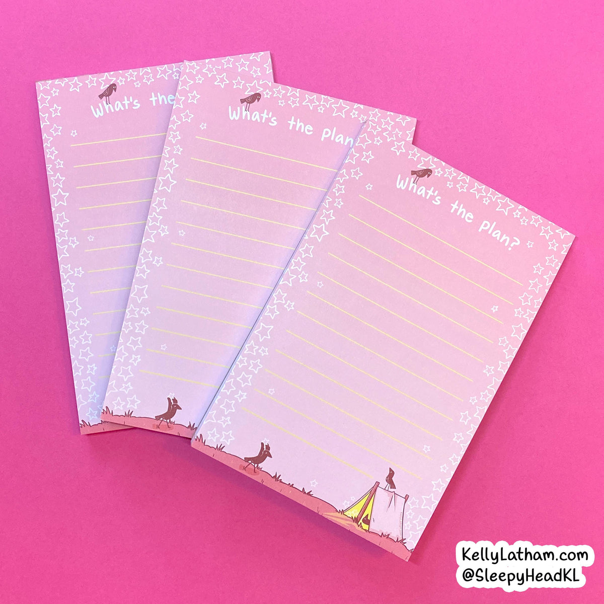 Three pastel pink notepads with white star borders and the phrase 'What's the plan?' stacked diagonally on a solid pink background. The notepads feature whimsical illustrations of animals and a small tent at the bottom.