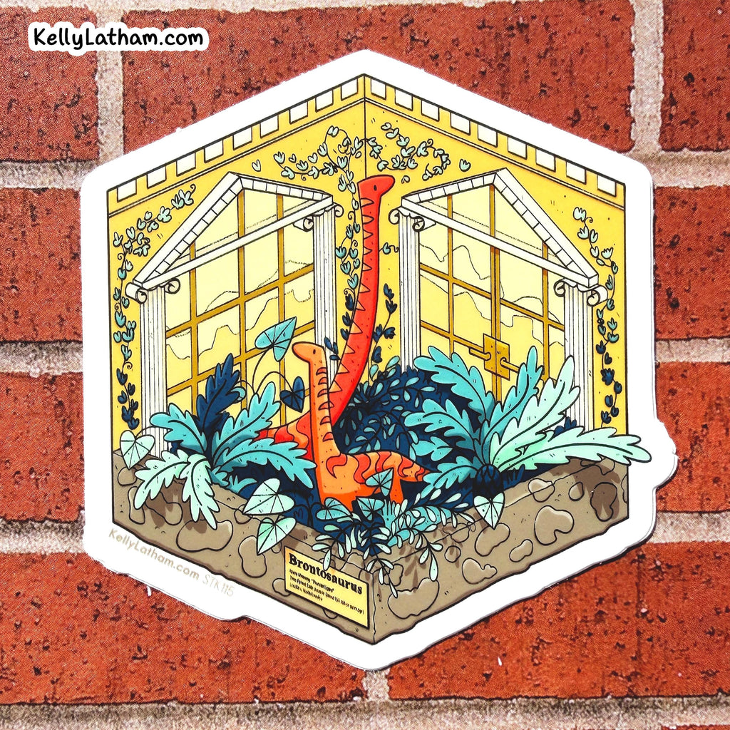A die-cut sticker featuring an illustrated greenhouse scene with two orange long-necked dinosaurs among blue and green plants, shown against a red brick wall. The sticker has a white border and the text 'KellyLatham.