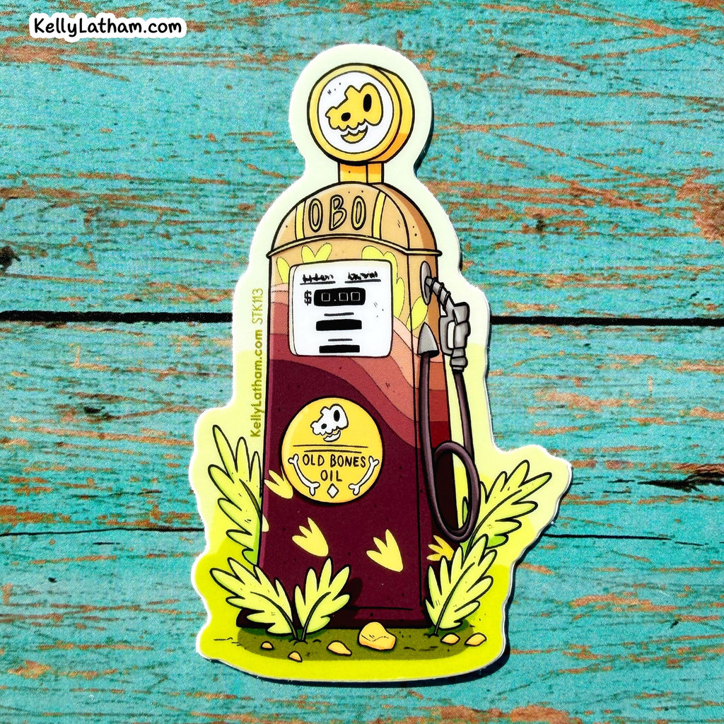 A die-cut sticker featuring a cartoon gas pump with the text 'Old Bones Oil' and a dog face on the dial, placed on a rustic turquoise wooden surface. The sticker includes the brand name 'KellyLatham.