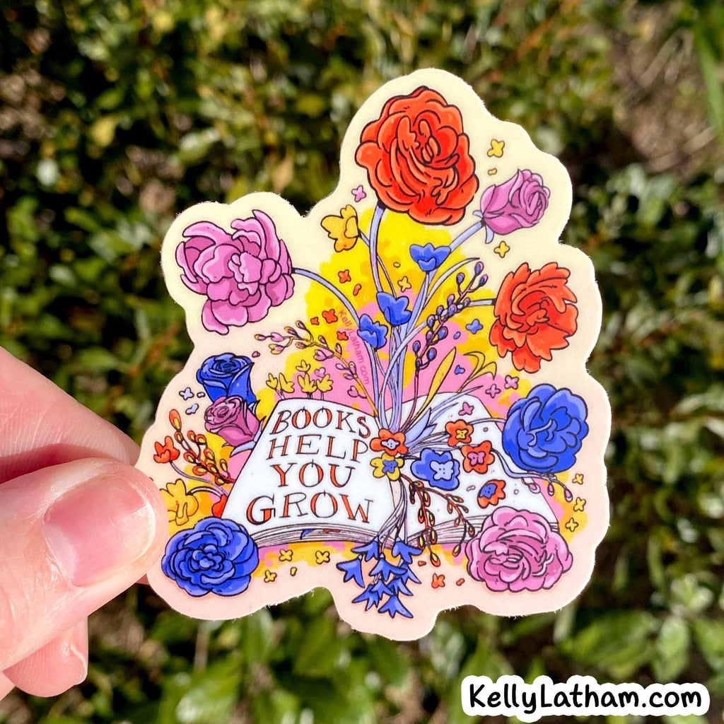 Colorful sticker with flowers and 'Books Help You Grow' text held against a green leafy background.