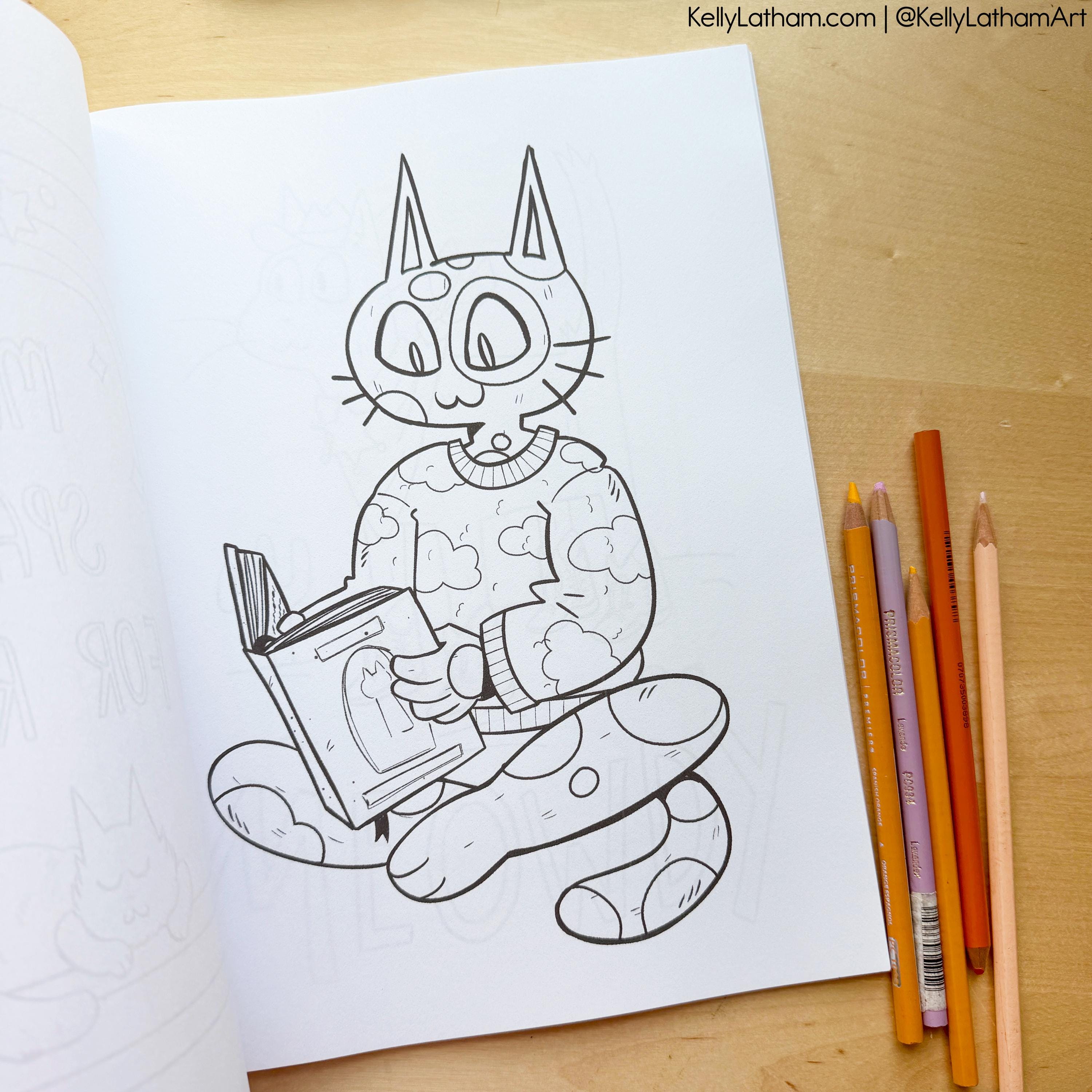 A black-and-white cartoon cat coloring page from an open coloring book, placed on a light wood surface with colored pencils beside it. The page shows a whimsical seated cat reading a book, and the top right includes the text KellyLatham.