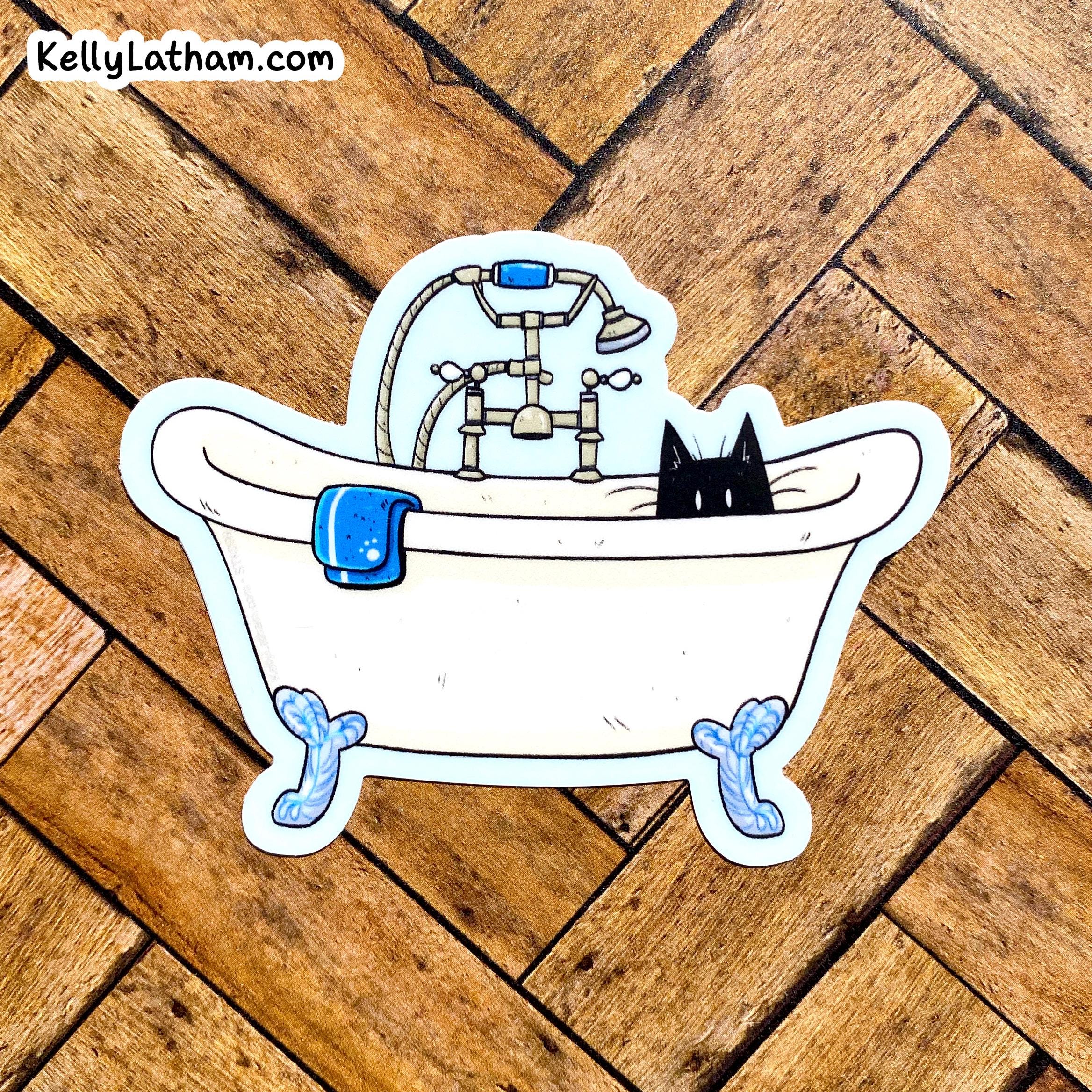 A die-cut sticker featuring a cartoon bathtub scene with a black cat, blue towel, and shower fixture, placed on a wooden floor. The sticker has a white border and the text 'KellyLatham.