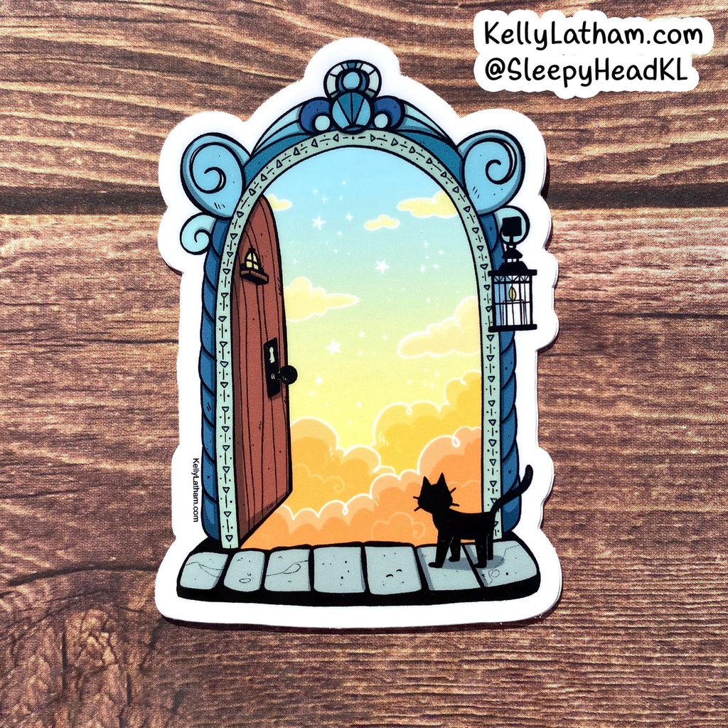 A die-cut sticker featuring an illustration of a black cat standing in front of an ornate blue doorway that opens to a pastel sky with clouds, placed on a wooden surface. The sticker has a white border, and the text 'KellyLatham.