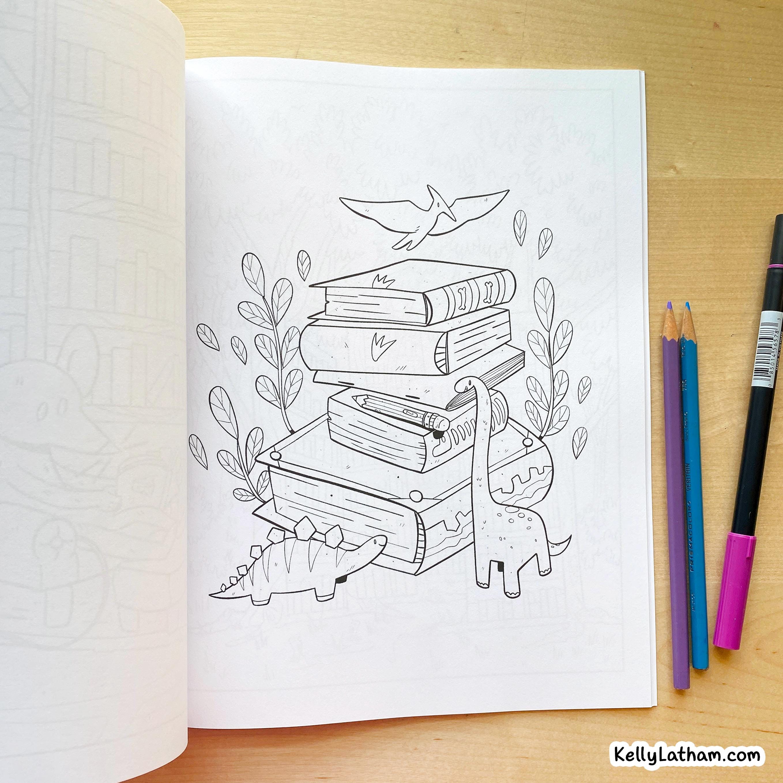 An open coloring book or journal on a wooden table, showing a black-and-white line art illustration of stacked books, dinosaurs, leaves, and a bird. Three colored pencils and a marker are placed to the right.
