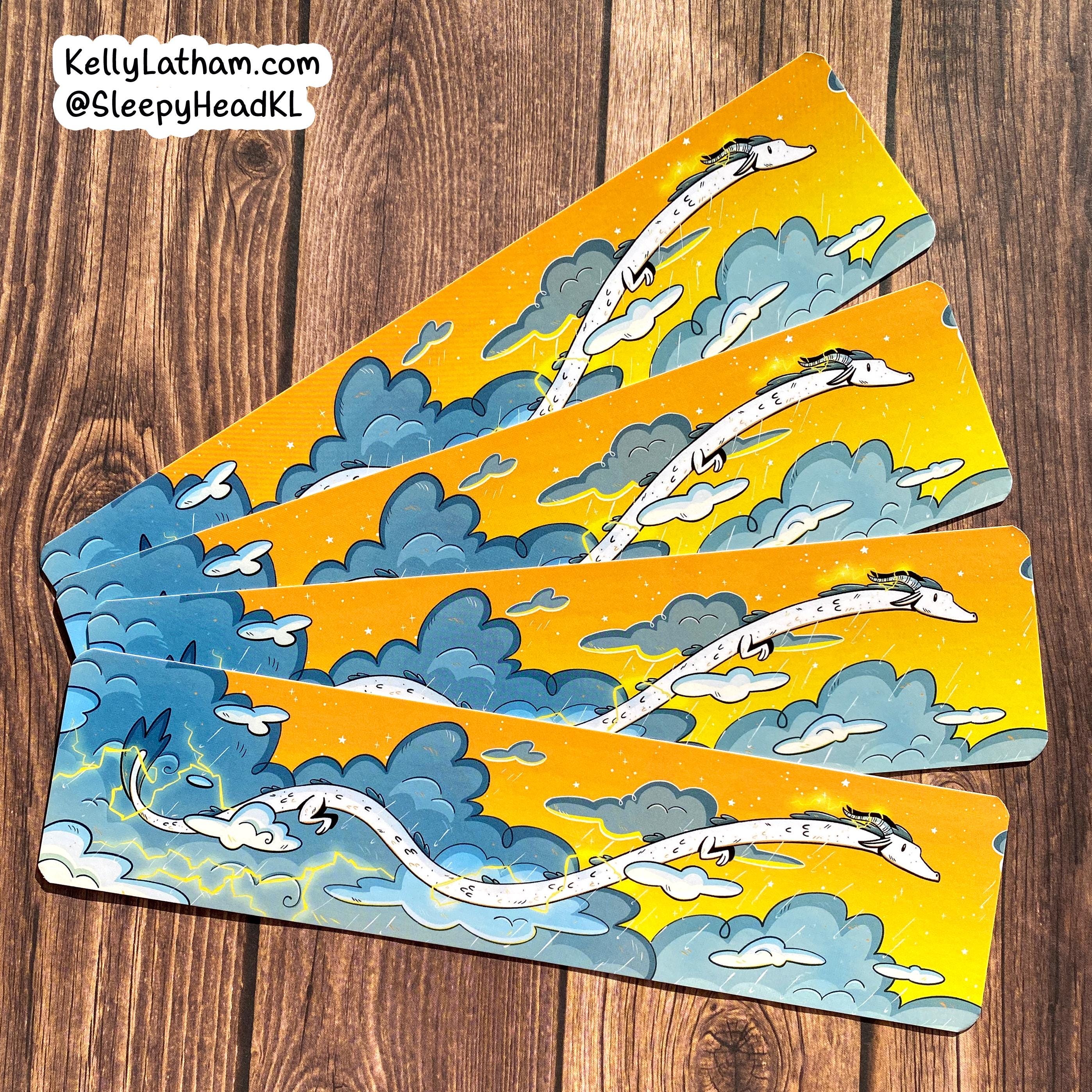 Three dragon-themed bookmarks on a wooden surface with 'KellyLatham.com @SleepyheadKL' text.