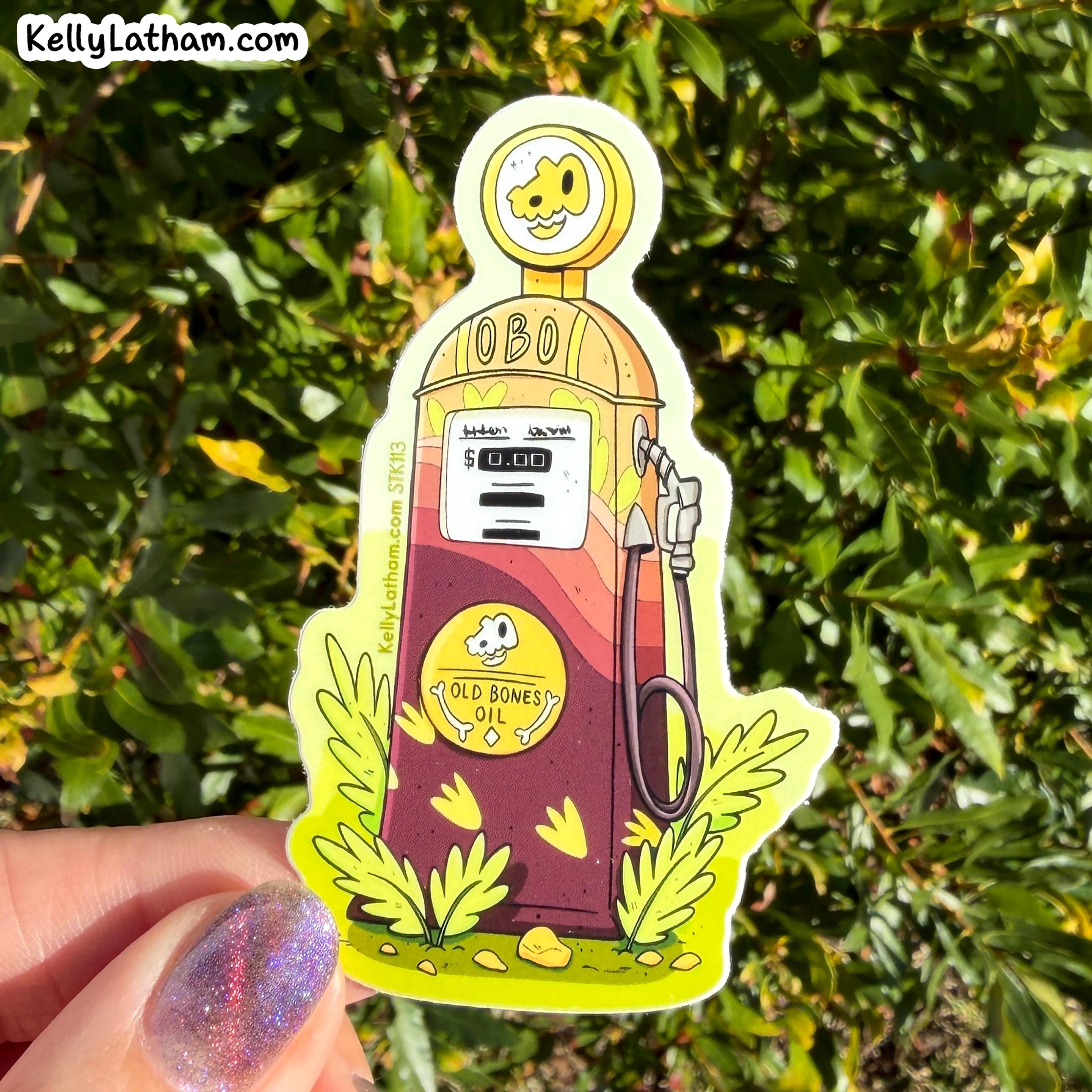 A die-cut sticker featuring a retro cartoon oil pump with the text 'OBO' and 'OLD BONES OIL', held by a hand against a background of green foliage. The sticker has a white border and is shown outdoors.
