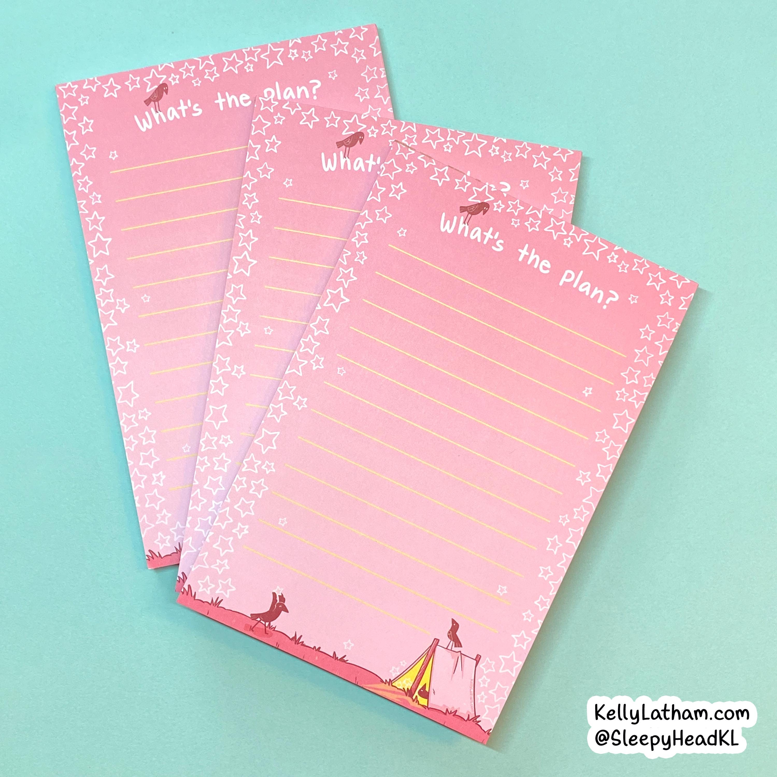 Three pink lined notepads with a star border and circus-themed illustrations, arranged on a light blue background. The notepads feature the text 'What's the plan?' and a small watermark in the bottom right corner reading 'KellyLatham.