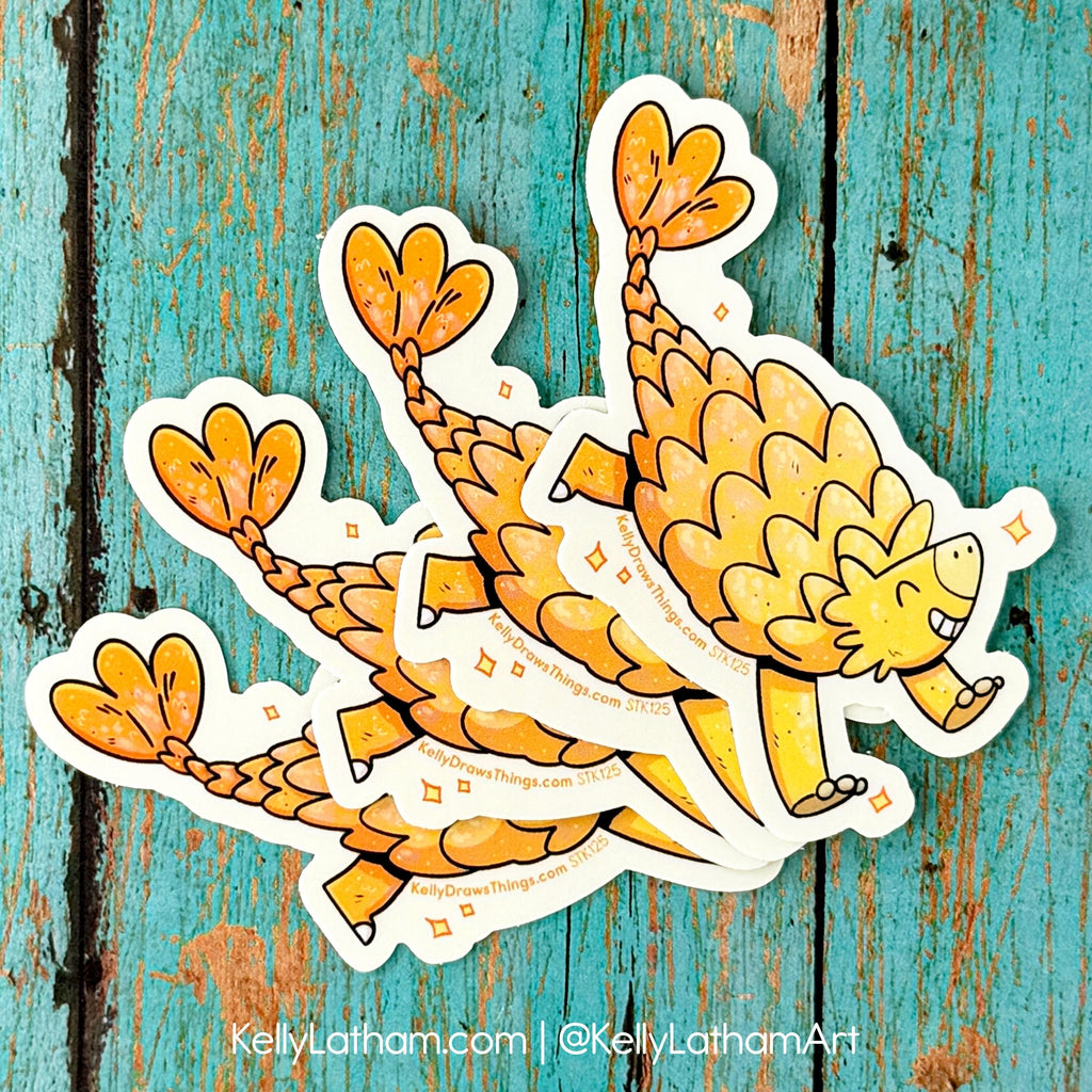 Three cartoon ankylosaurus stickers on a textured blue background