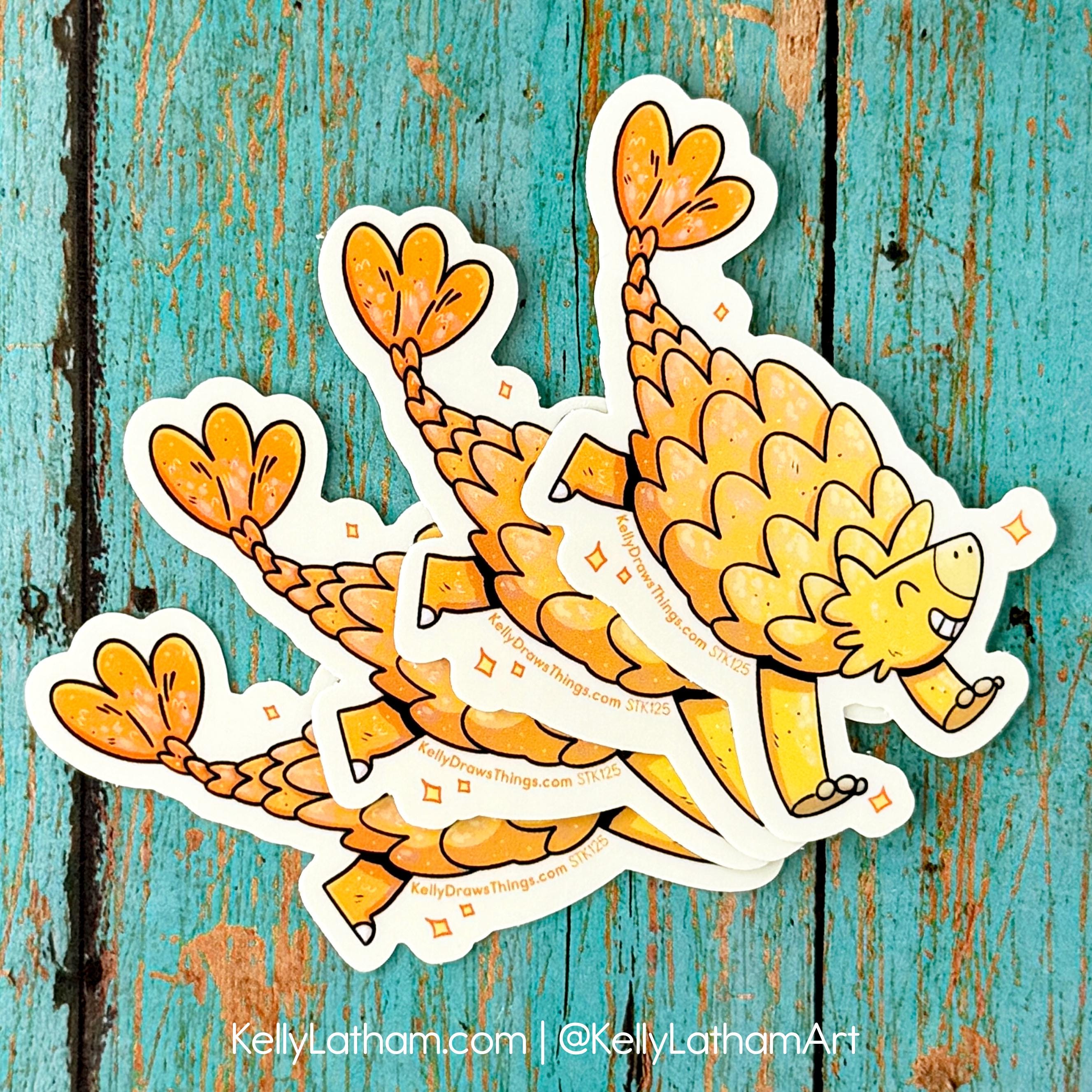 Three cartoon ankylosaurus stickers on a textured blue background