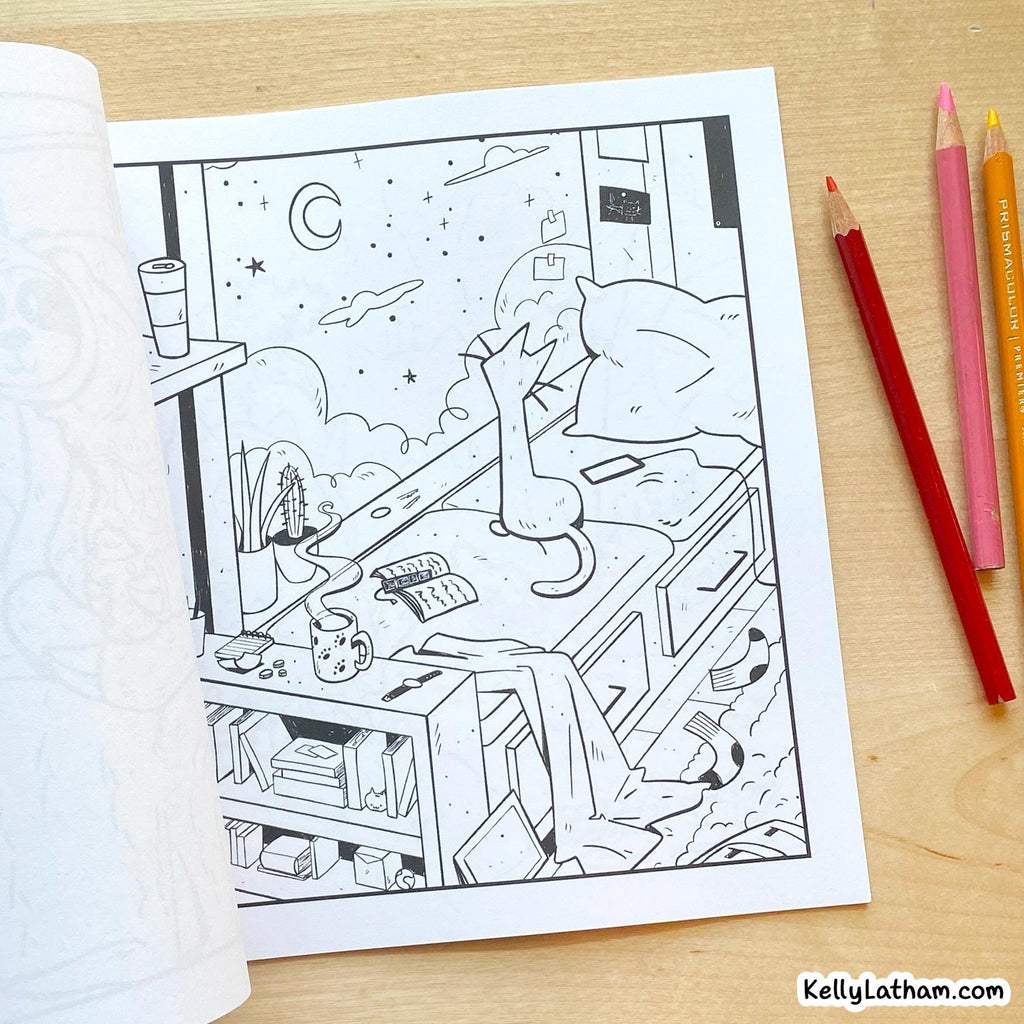 A black-and-white coloring page featuring a cozy bedroom scene with a cat on a bed, shown on a light wood desk alongside colored pencils. The brand name KellyLatham.