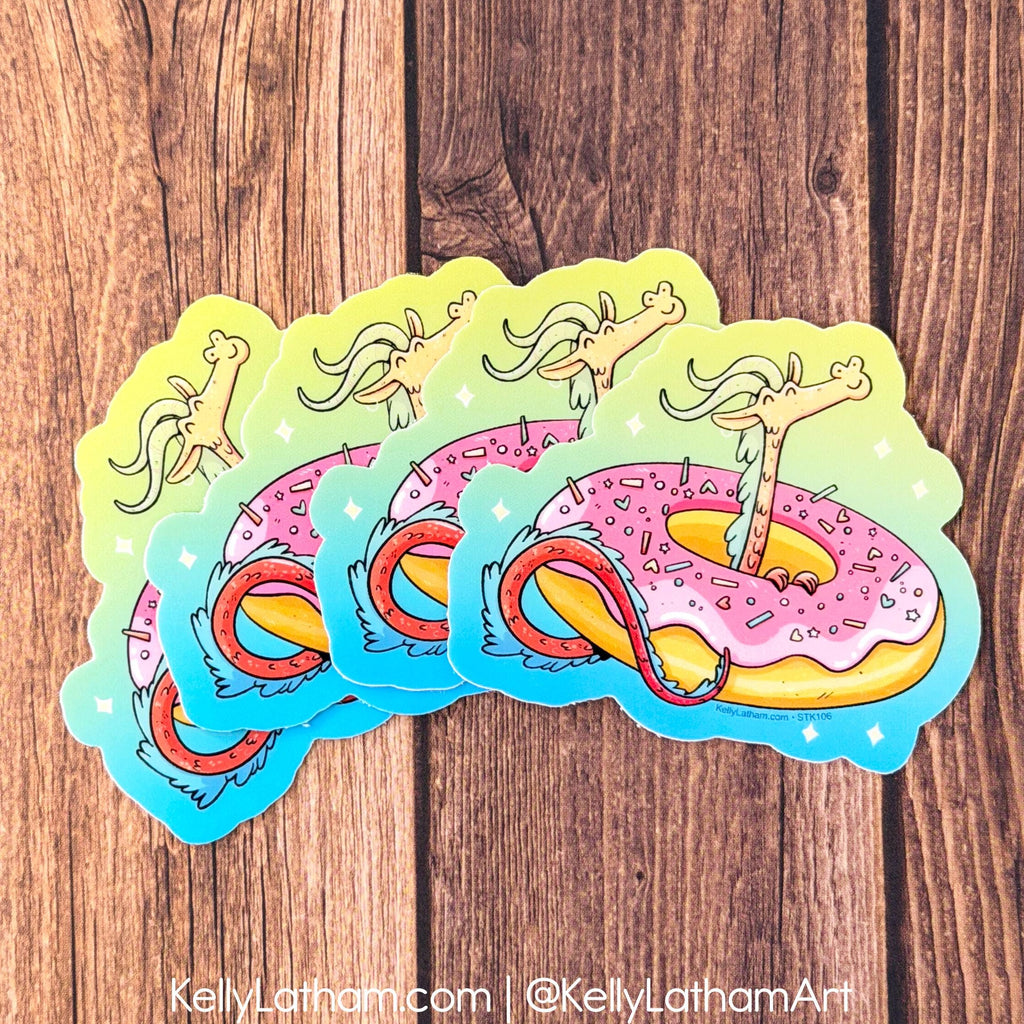 Four die-cut stickers featuring a whimsical cartoon giraffe emerging from a pink frosted donut, arranged in a fan shape on a rustic brown wooden background.