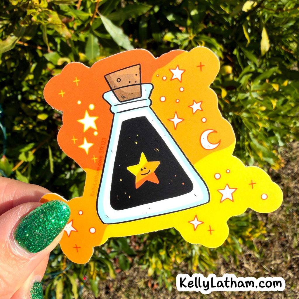 Sticker of a potion bottle with a star inside, held against a natural background.