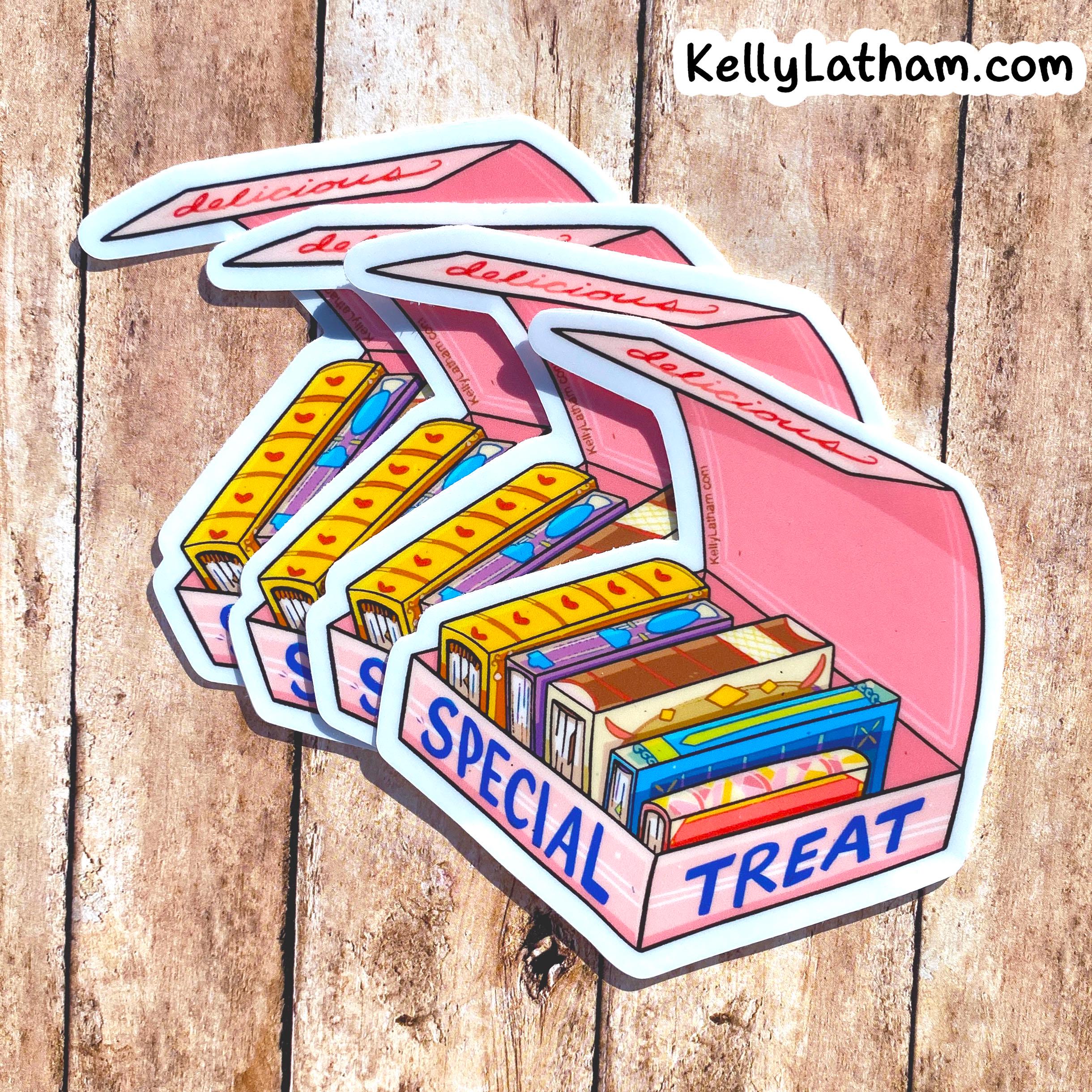 A set of illustrated die-cut stickers shaped like an open pink candy box labeled 'SPECIAL TREAT,' filled with colorful candy bars, displayed on a rustic wood plank background. The brand text 'KellyLatham.