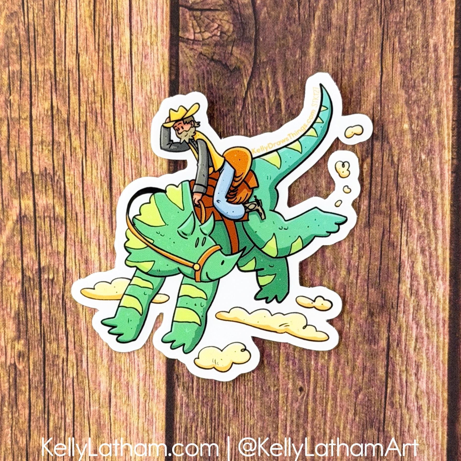 Sticker of a cartoon character riding a green dragon on a wooden background, with branding information.