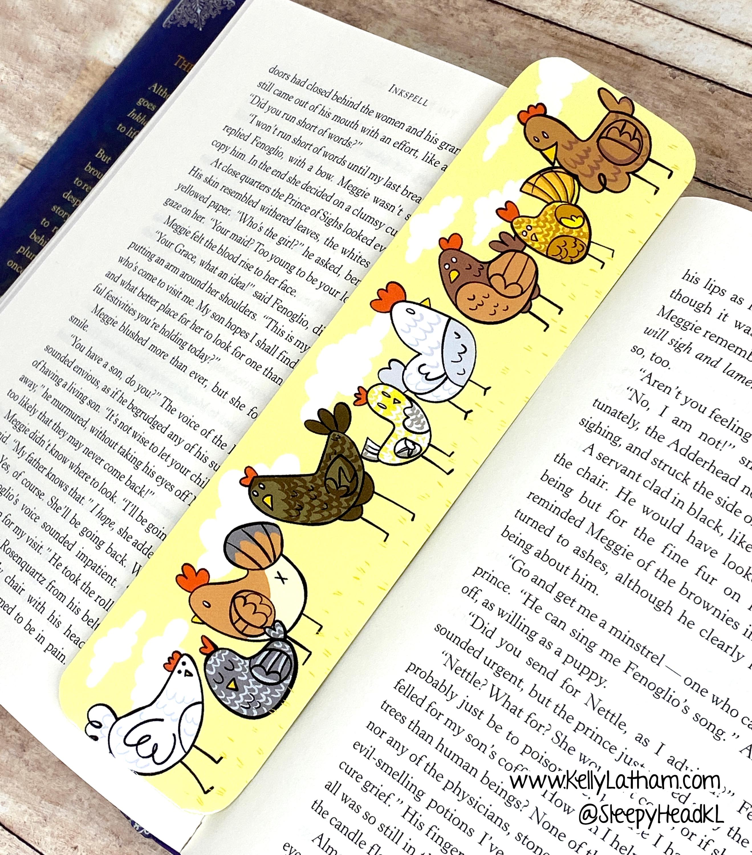 Bookmarks with cartoon chicken designs on a book