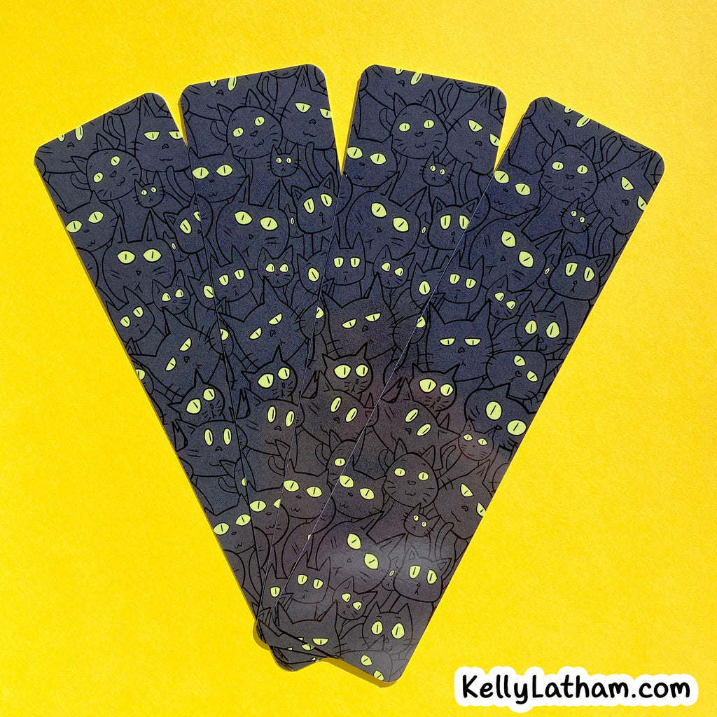 A set of five tarot cards fanned out against a bright yellow background. The cards feature a dark charcoal/black background patterned with numerous black cat silhouettes and glowing yellow-green eyes.