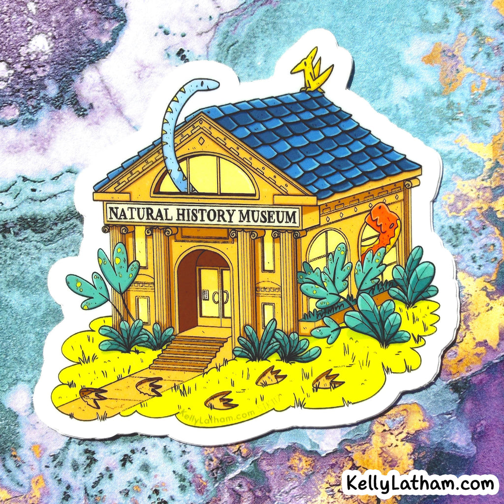 A die-cut sticker featuring an illustrated natural history museum with a blue tiled roof, yellow walls, green plants, and a blue dinosaur tail rising from the roof, shown on a colorful marbled background. The sticker reads 'NATURAL HISTORY MUSEUM' and has 'KellyLatham.