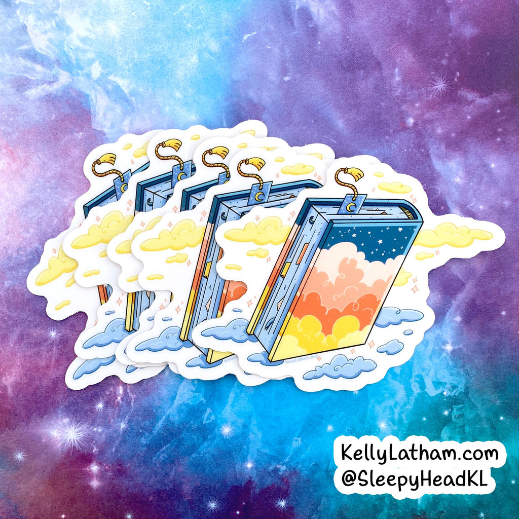 A die-cut sticker featuring three floating books with golden bookmarks, surrounded by yellow clouds against a colorful galaxy background. The sticker is shown on a purple and blue nebula backdrop, with the text 'KellyLatham.