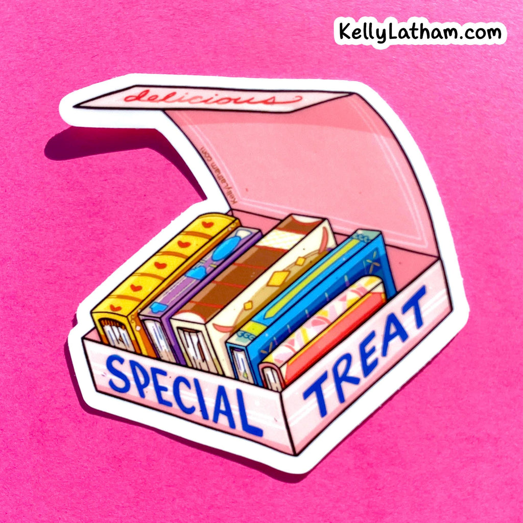 A die-cut sticker featuring an illustration of a pink 'Special Treat' box filled with colorful books, shown on a solid pink background. The brand name 'KellyLatham.