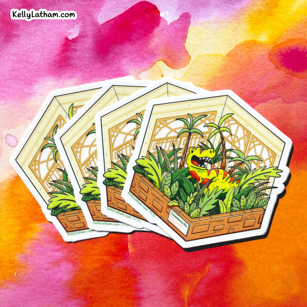 Three hexagonal die-cut stickers featuring a cartoon green dinosaur in a tropical jungle scene, arranged in a fan shape against a vibrant watercolor background. The brand name 'KellyLatham.