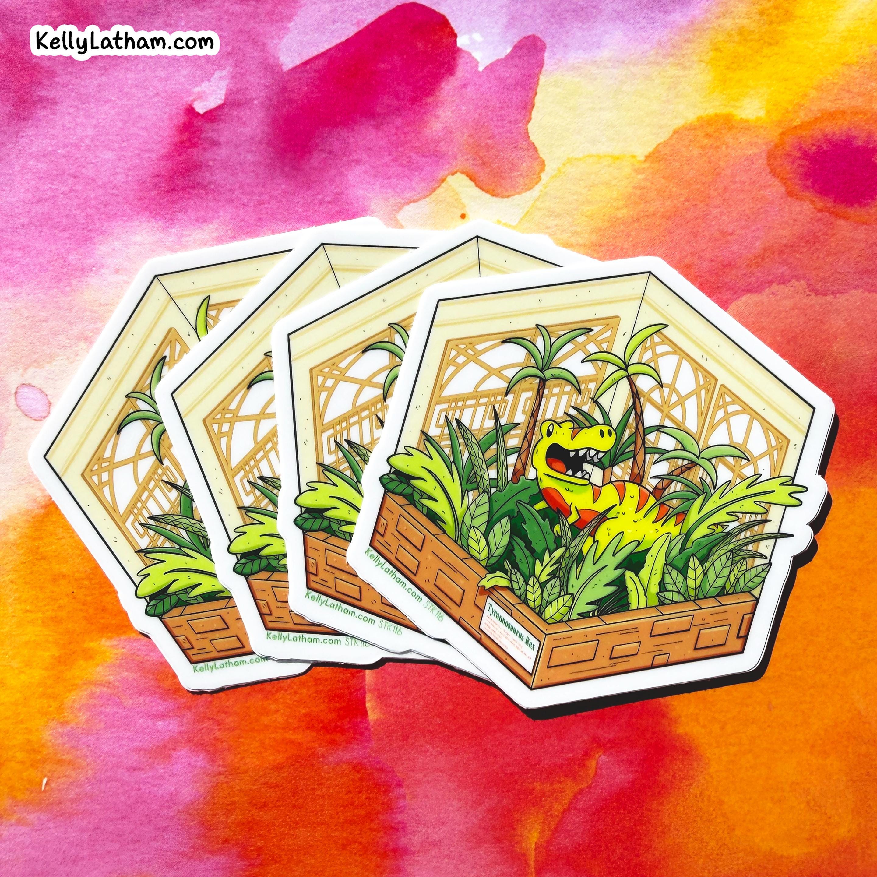 Three hexagonal die-cut stickers featuring a cartoon green dinosaur in a tropical jungle scene, arranged in a fan shape against a vibrant watercolor background. The brand name 'KellyLatham.