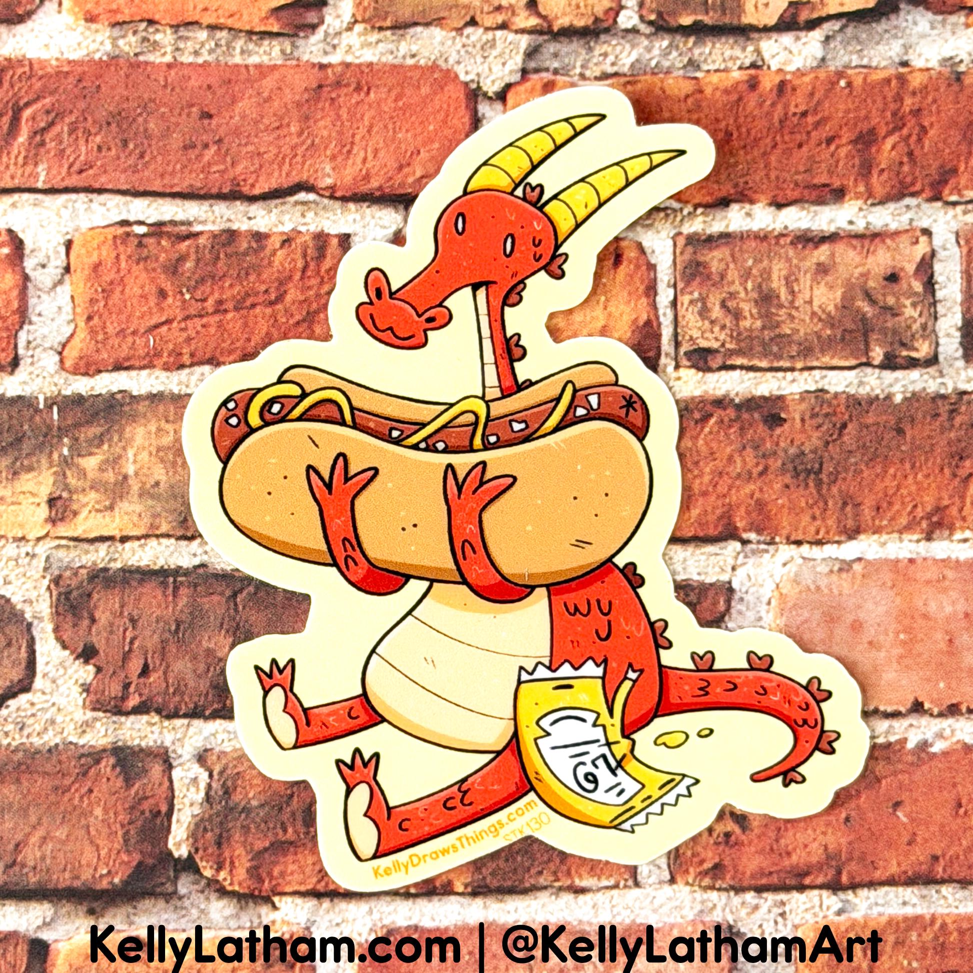 A die-cut sticker featuring a whimsical red dragon carrying a hot dog with mustard and relish, and holding a bag of chips, shown against a red brick wall background. The sticker has a cream border and includes the text 'KellyLatham.