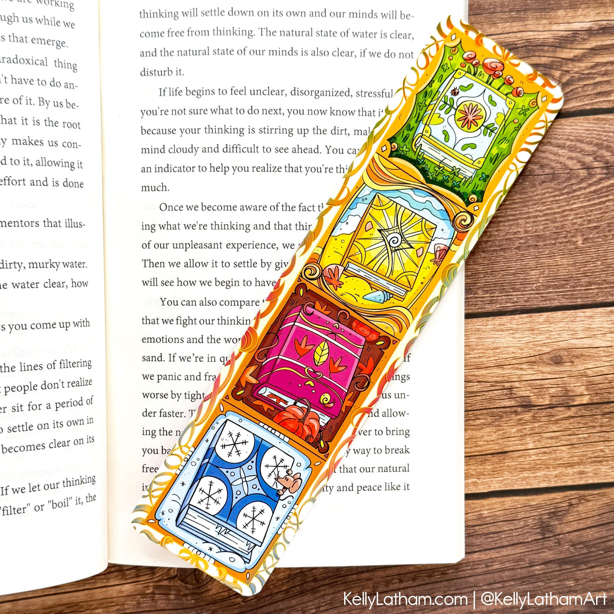 A colorful, hand-painted Thai wooden bookmark with intricate illustrations of a pink lotus flower, a green lotus leaf, and a yellow sun, displayed on an open book over a wooden surface.