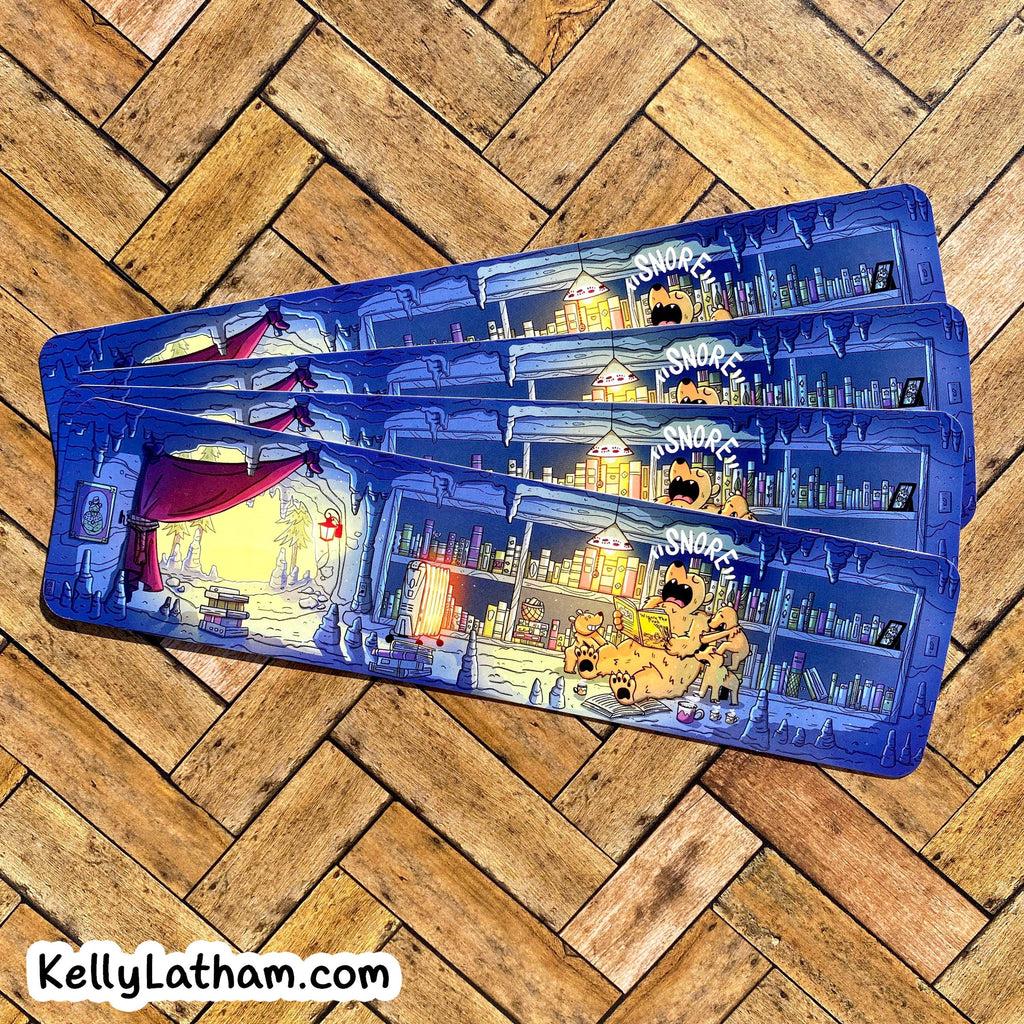 Three blue hardcover pencils with detailed cartoon illustrations of a library scene and the word 'SNORKEL' on the covers, arranged diagonally on a wooden parquet floor.