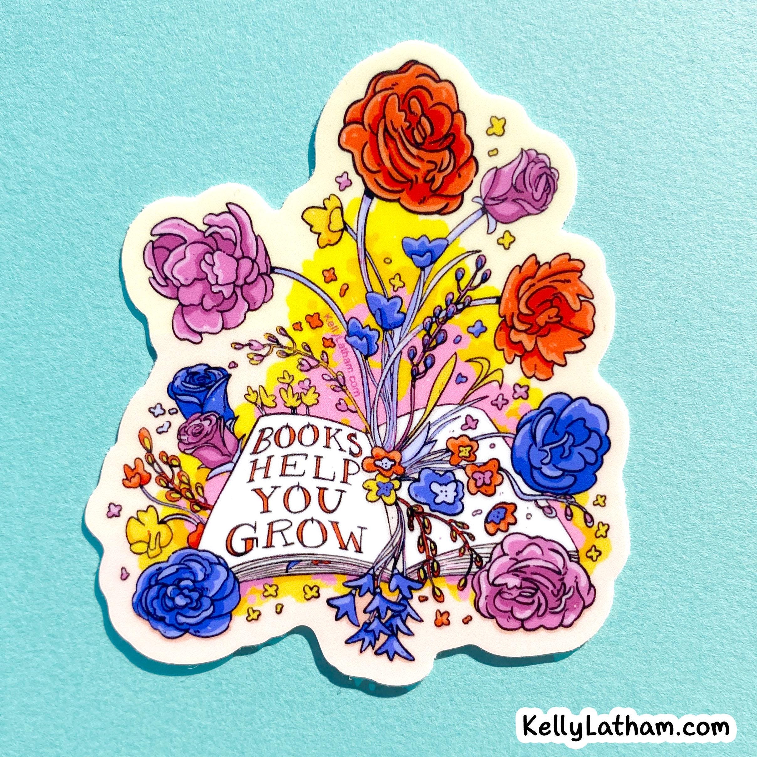 A die-cut sticker featuring a colorful illustration of an open book surrounded by flowers and the words 'BOOKS HELP YOU GROW,' shown on a light blue textured background.