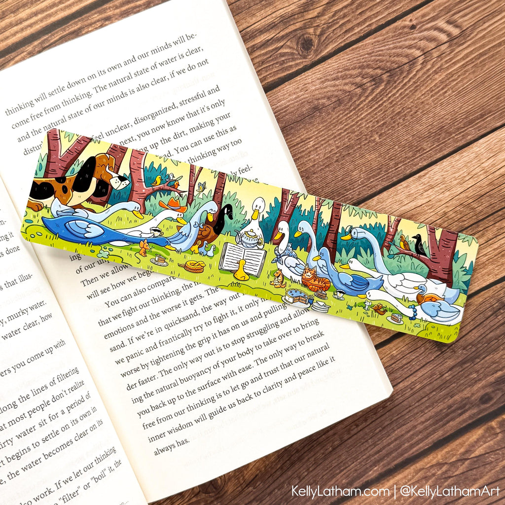 Duck Storytime bookmark laid in an open book featuring illustrated ducks, ducklings, and woodland scenery against dark wood background.