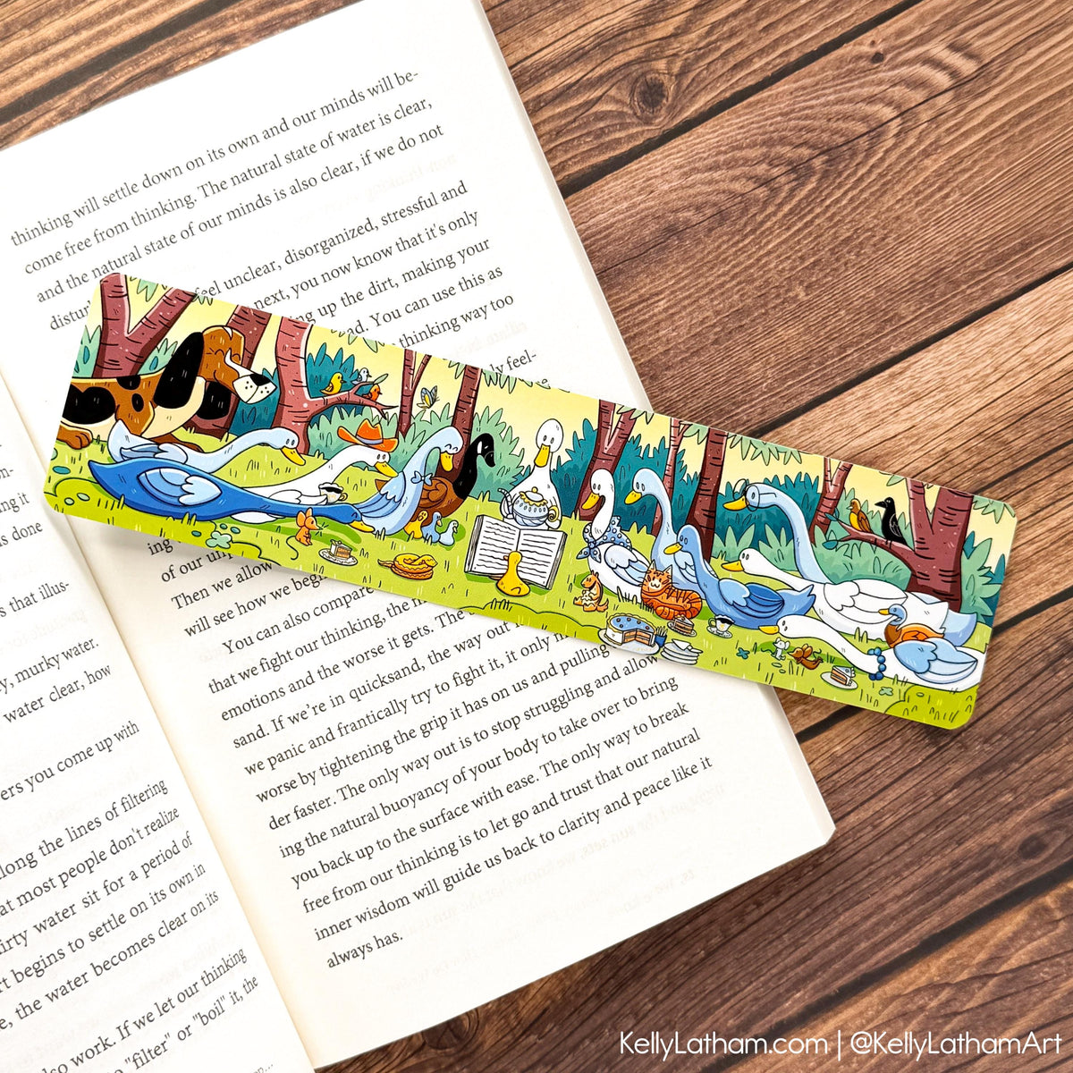 Duck Storytime bookmark laid in an open book featuring illustrated ducks, ducklings, and woodland scenery against dark wood background.