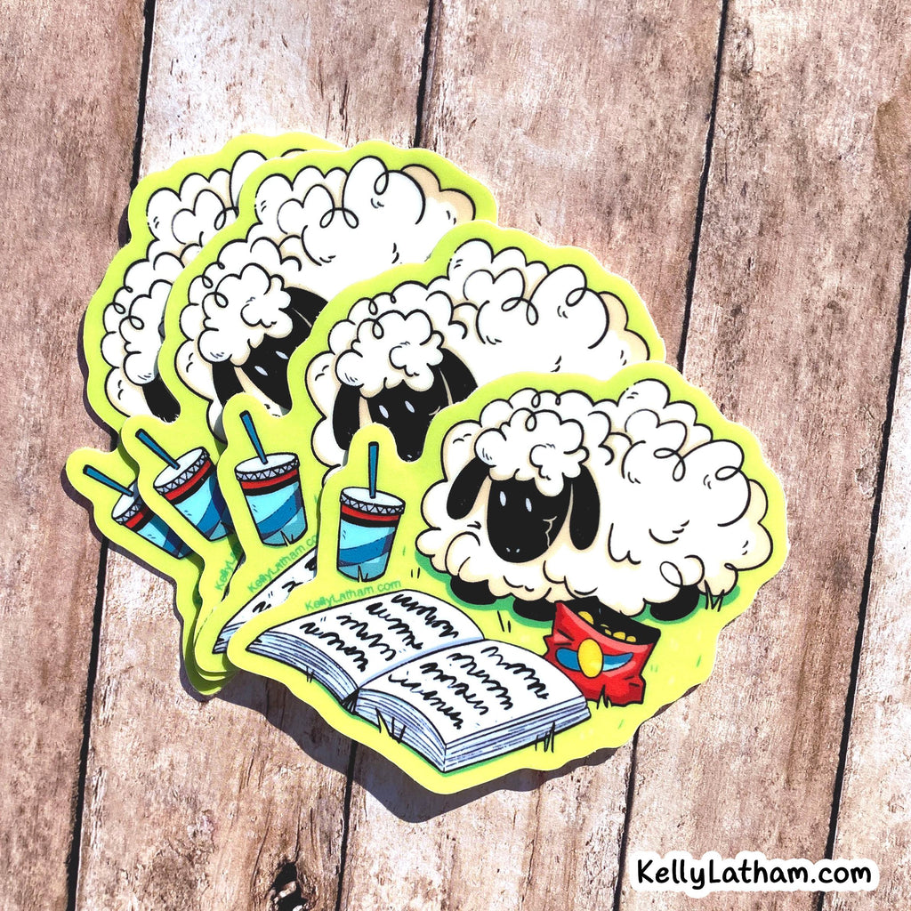 A set of cartoon sheep stickers fanned out on a rustic wooden surface. The sheep stickers are white with black faces and black legs, wearing red and yellow clothing, with one sheep reading an open book.